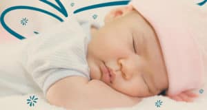 Taking Care of a Newborn: Close up of a cute, baby Asian girl sleeping on her stomach with her head resting on her forearms