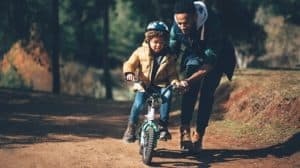 Father teaching son how to ride a bike