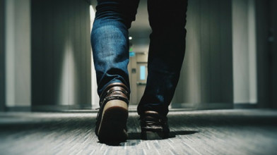 picture of feet walking down a long hallway