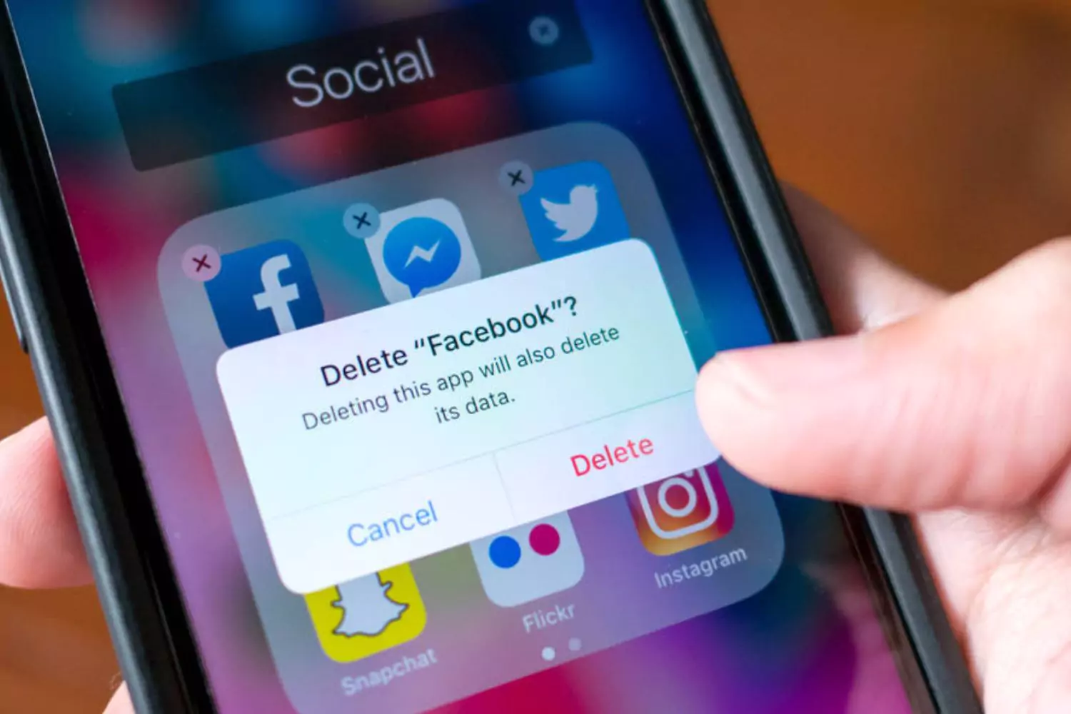 Facebook user deleting Facebook application on cell phone
