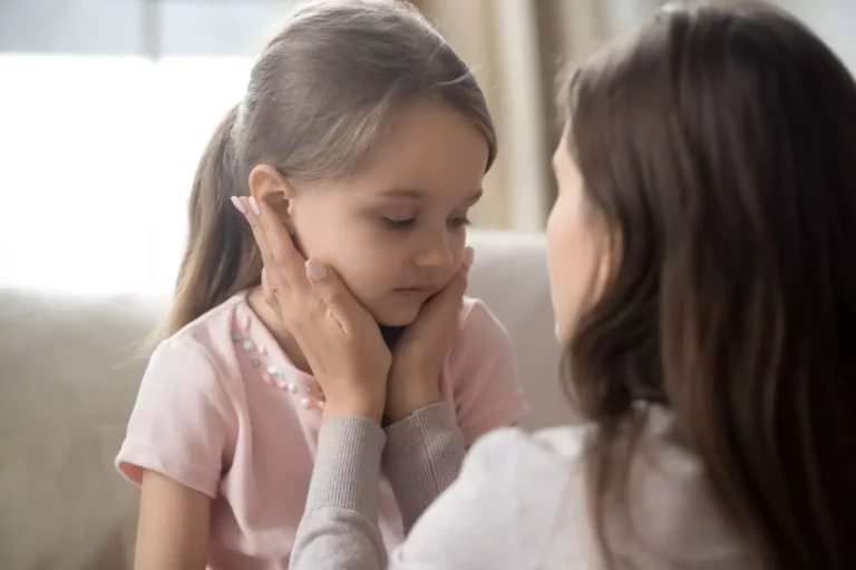 Mother with her daughter's face in her hands giving her godly discipline in love