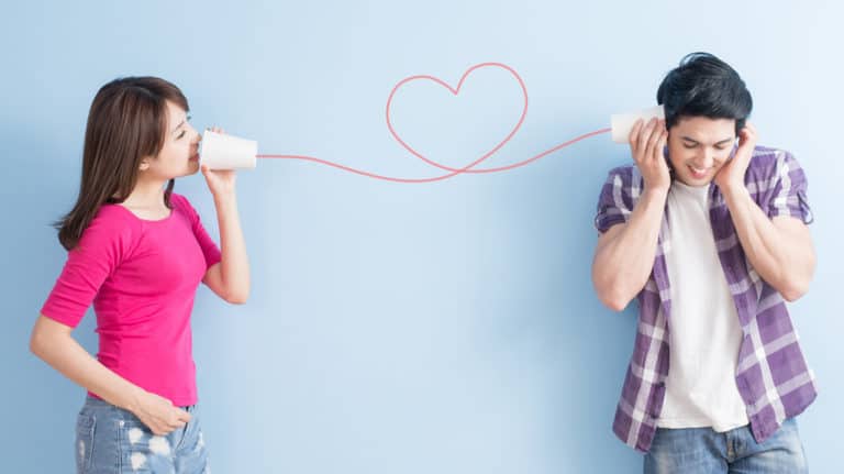 husband and wife talking on pretend phone