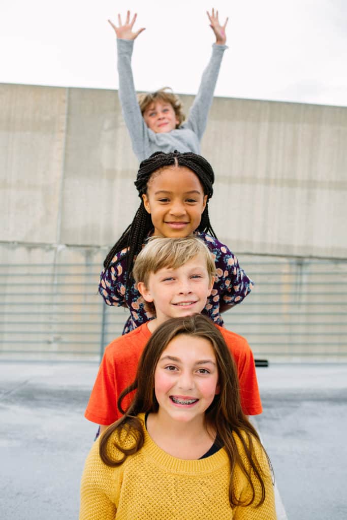 four pre-teens hanging out together