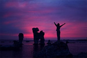Silhouette of a woman raising her arms
