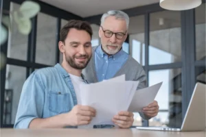 Adult man and his father looking over finances