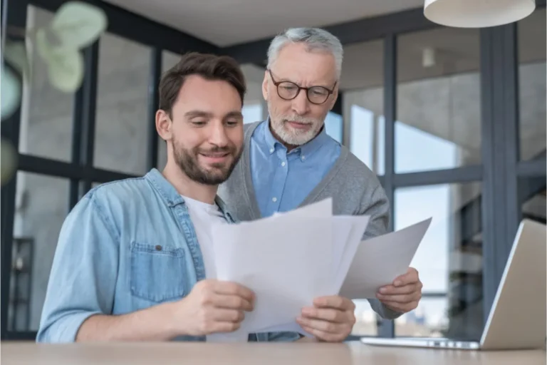 Adult man and his father looking over finances