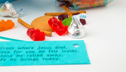 Close up of note with short poem about Jesus, with candy and snacks in background