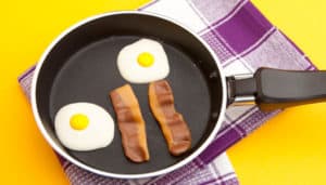 Close up of frying pan with fake eggs and bacon in it
