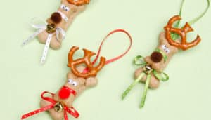 Close up of three dog treats creatively decorated as Christmas ornaments looking like reindeer