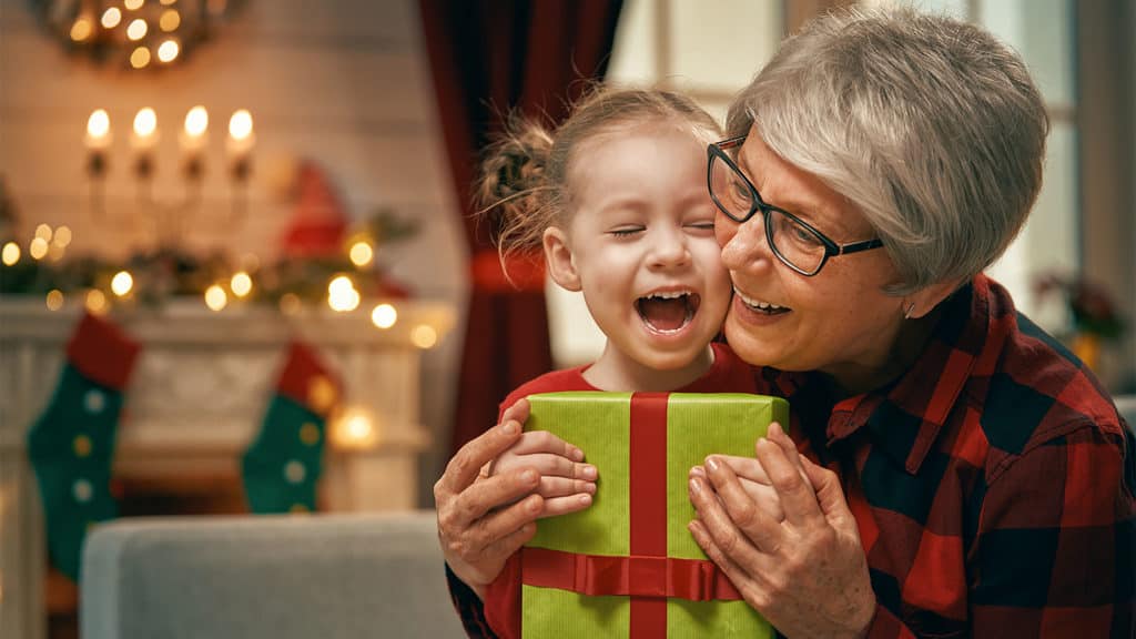 grandmother and grandchild with a present