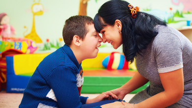 portrait of mother and her beloved son with disability in rehabilitation center