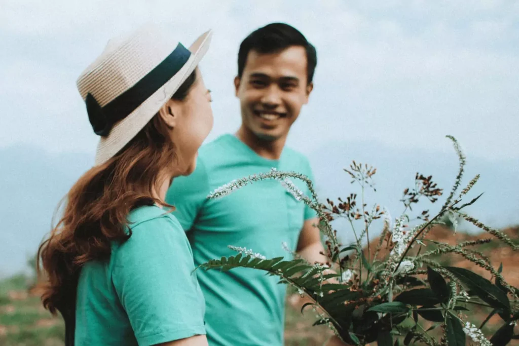 A smiling couple sharing a warm moment outdoors, symbolizing intimacy in marriage through connection and companionship.