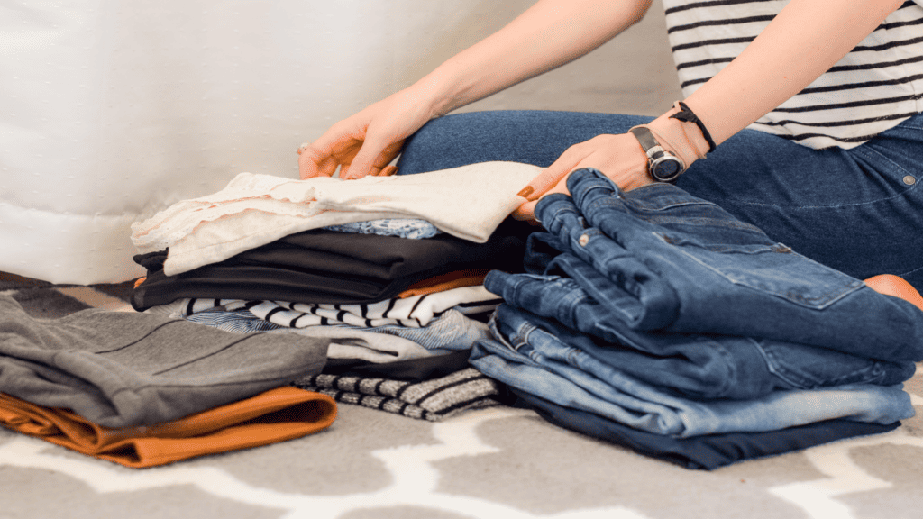 a married woman folds clothes to help with household chores