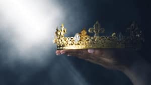 a person holds up a crown