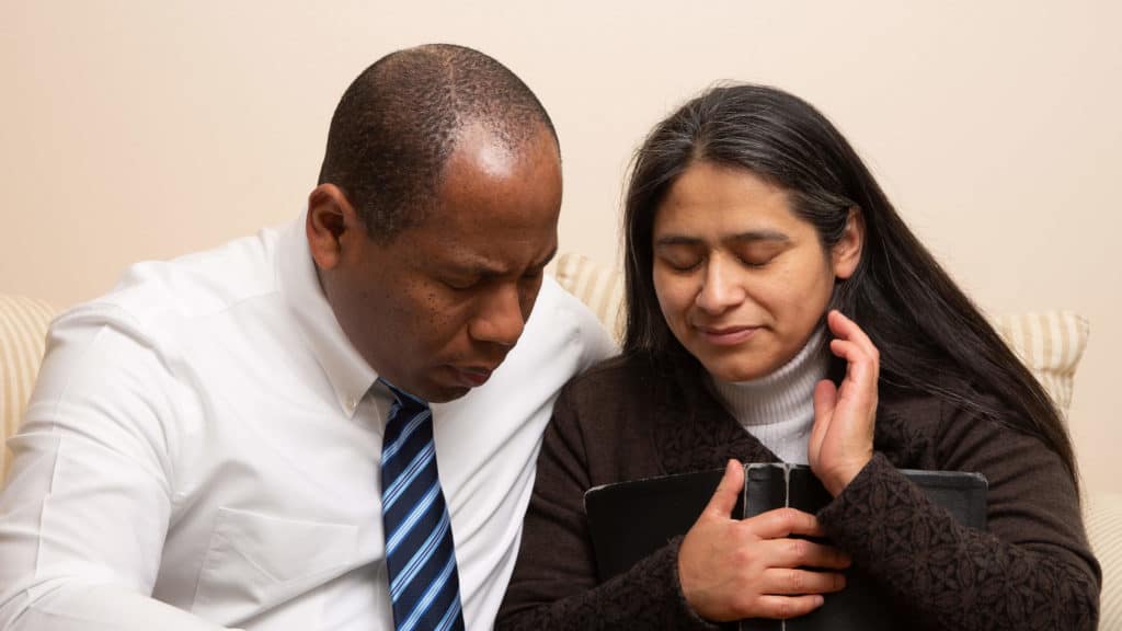 a man and woman pray together