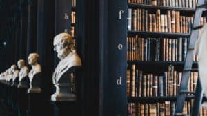 a row of statues in an old library