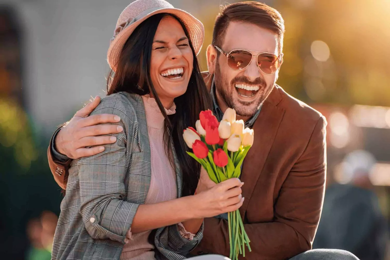 laughing couple with flowers valentines day