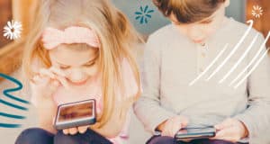 Stylized close up of a young boy and girl staring at smartphones