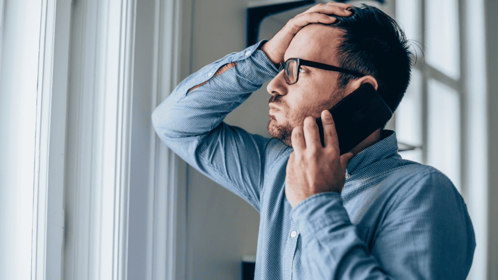 a man holding a phone to his ear