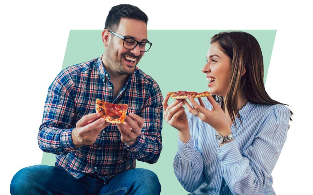 Speed date your spouse: Man and woman eat pizza and laugh