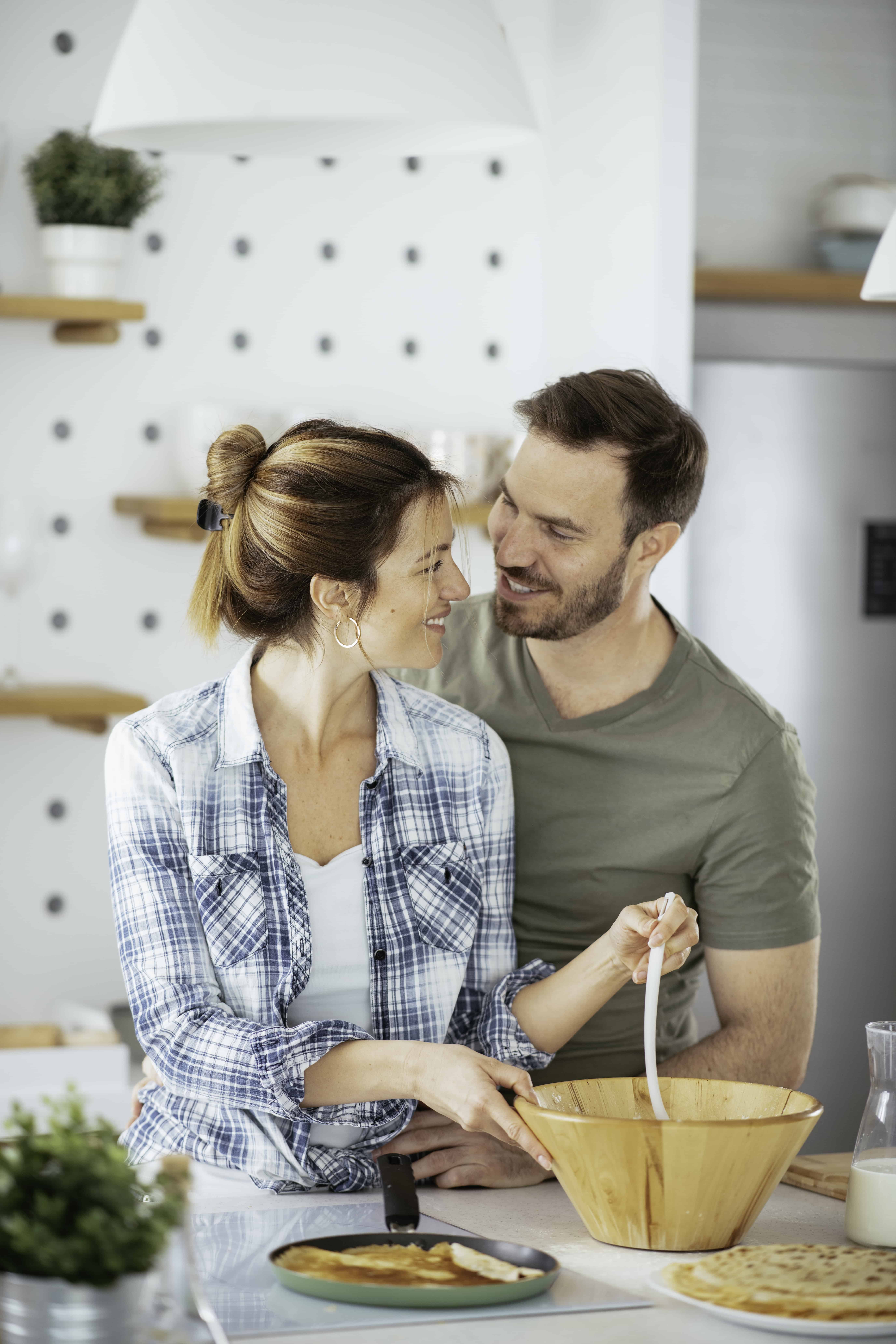 Moms need adult interaction during the stages of motherhood - Couple making breakfast together