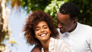 A young, happy African American couple embracing