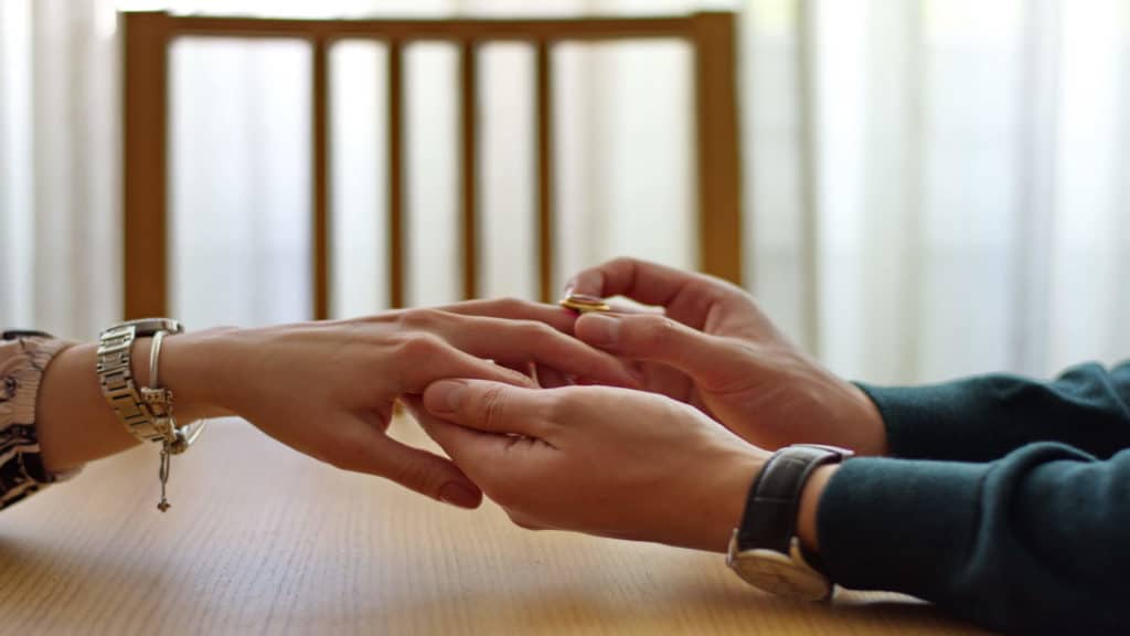 A man gives a woman an engagement ring