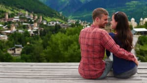A young man and woman enjoy the mountain view