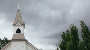 Church steeple with stormy-looking clouds in the background