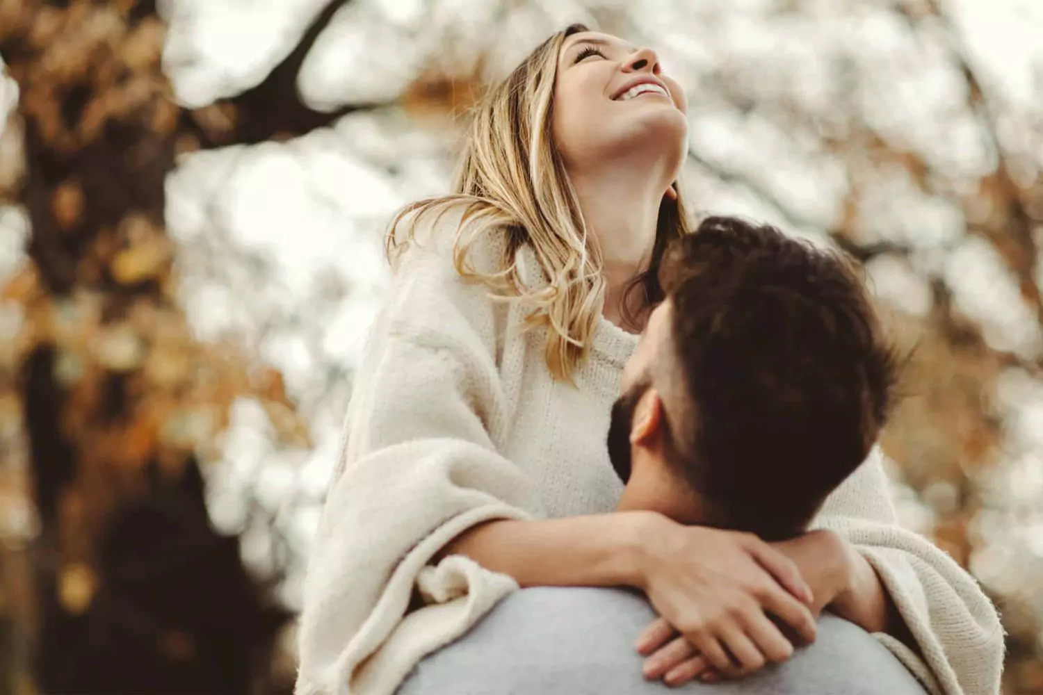 Husband picking up wife demonstrating love is patient and kind