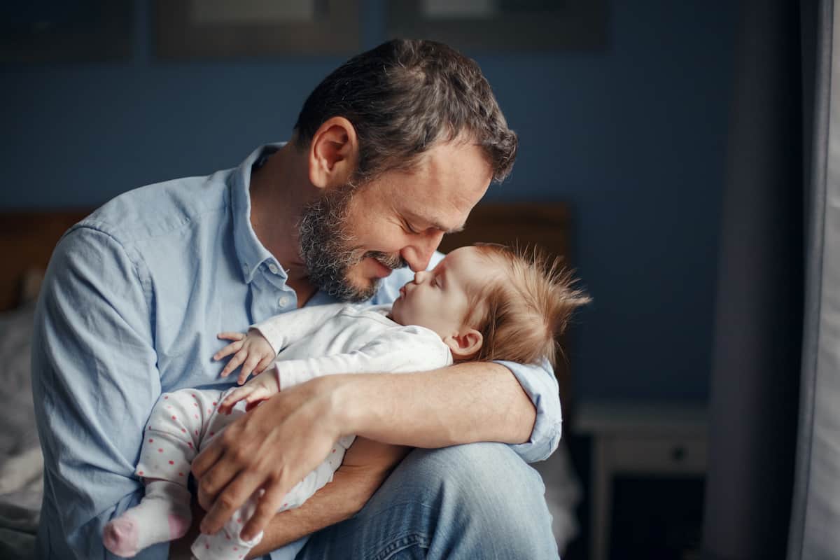 A father holds his infant