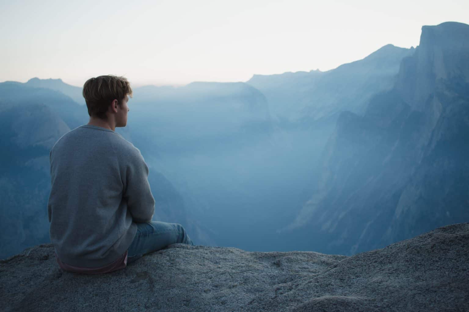 Young man sitting on mountain