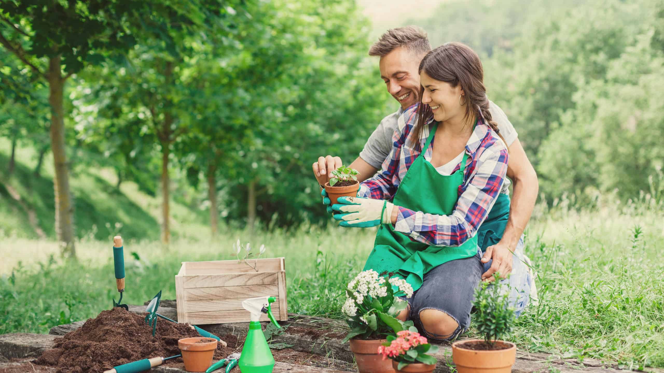 Young loving couple practice self-care by having fun with gardening work on a wooden floor during spring day