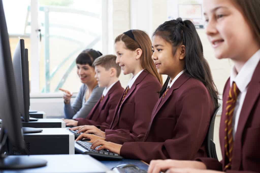 Students at a private school learning on the computer.