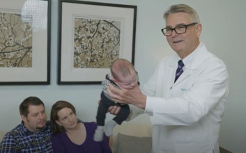 Dr. Robert Hamilton to demonstrate his popular 'Hamilton Hold' method for soothing a newborn baby.