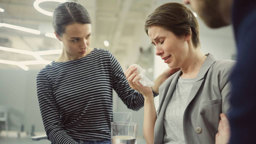 couple comforting woman with unplanned pregnancy