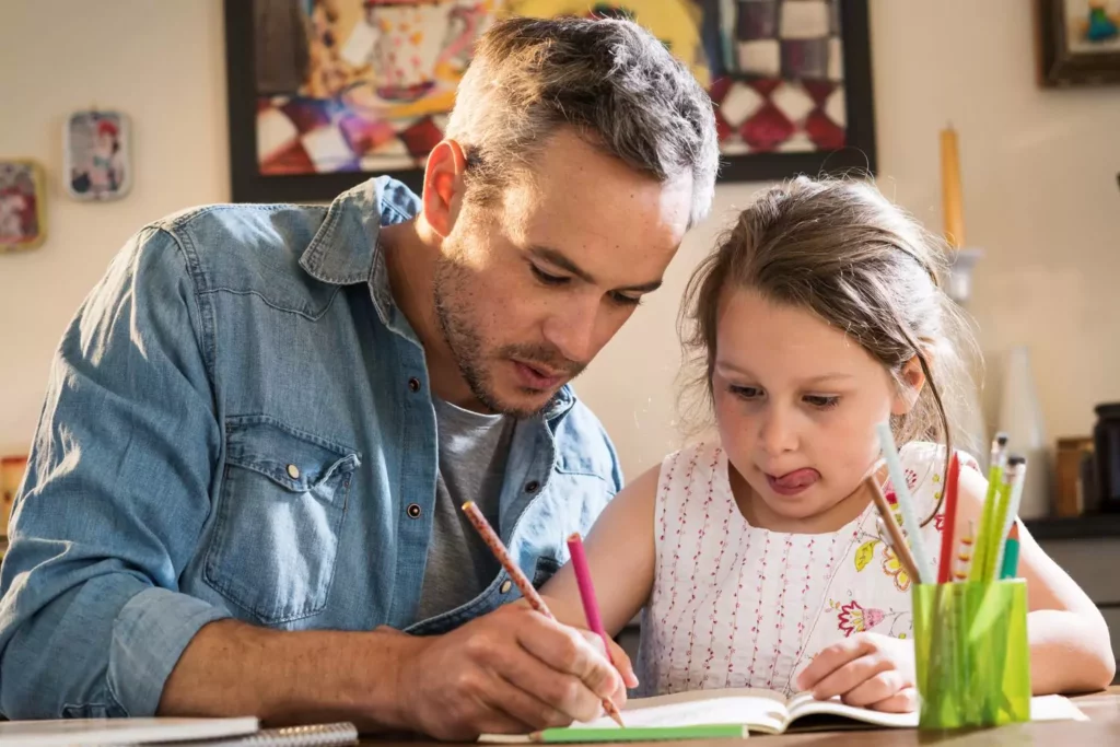 School choice is important to this father and his little girl doing school work together