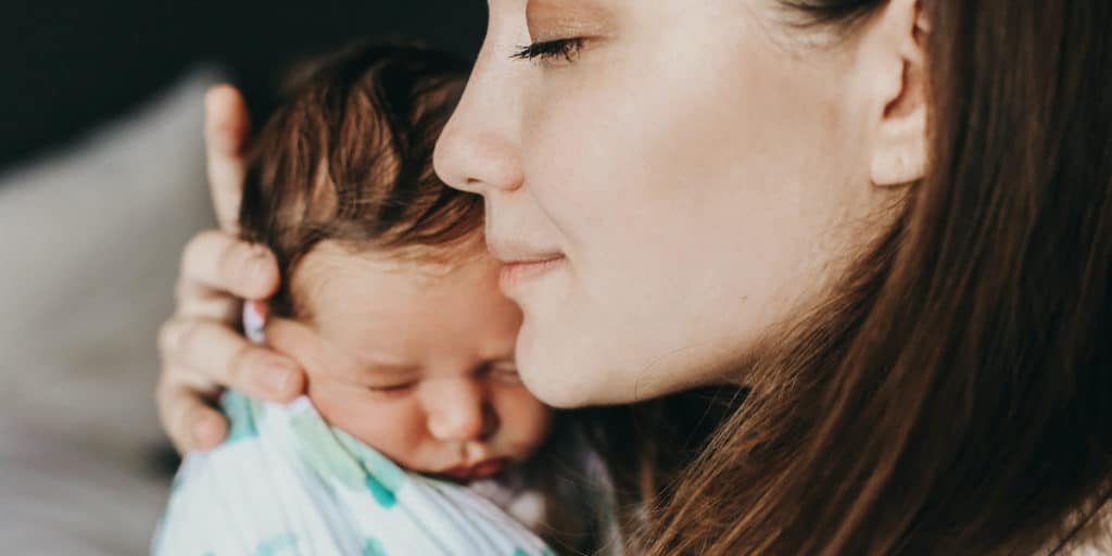 young birth mother with her newborn baby