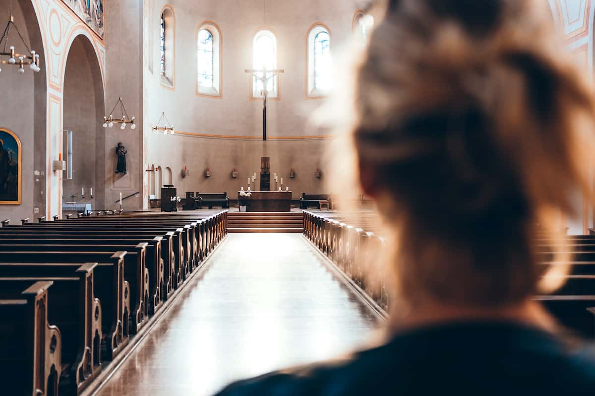 a parent of a disabled child stands alone in a sanctuary.