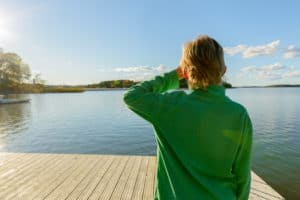 little boy standing on dock