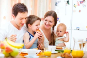 Dad, mom, and two young children at the breakfast table