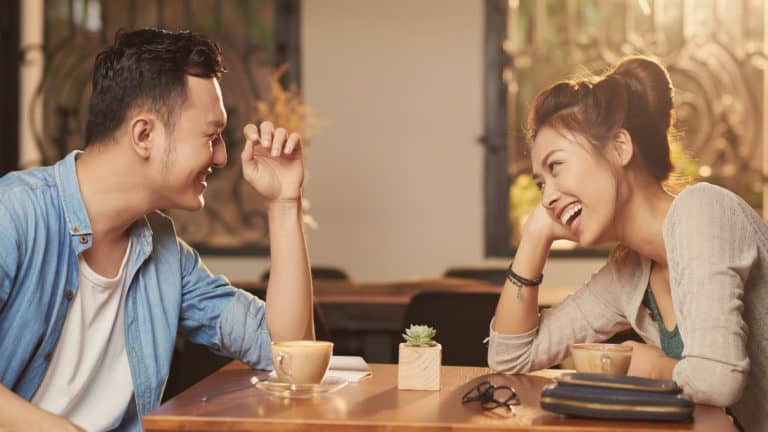 a man and woman talk at the dinner table