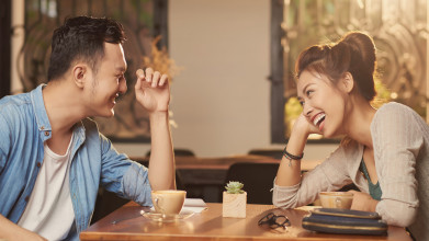 a man and woman talk at the dinner table