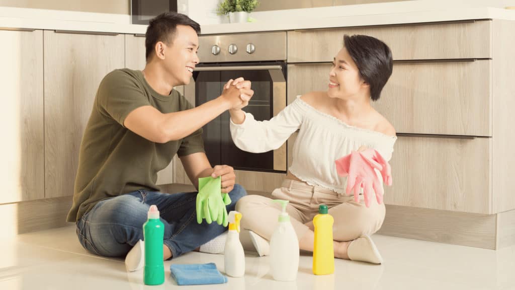 a couple cheers each other on while doing chores