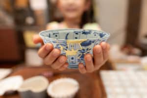 Child holding bowl repaired by kintsugi
