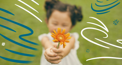 Stylized image of young Asian girl holding a flower up to the camera