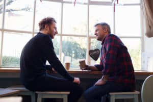 two men sitting in a coffee shop