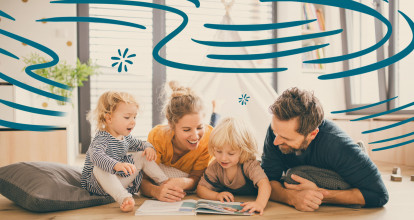 Family sitting on floor reading