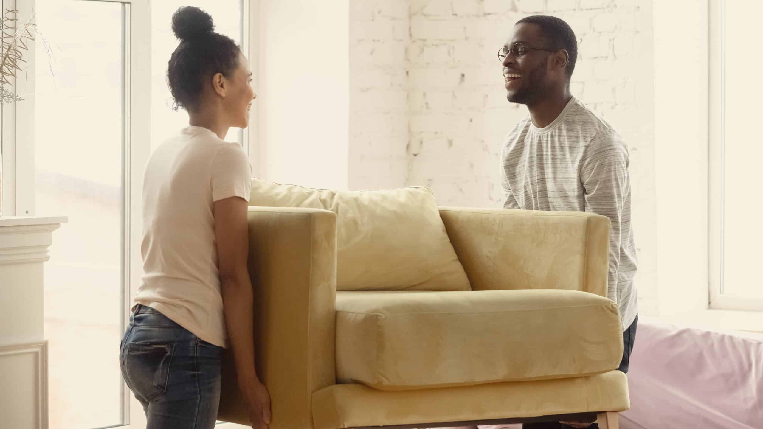 Young couple moving a chair and extending grace