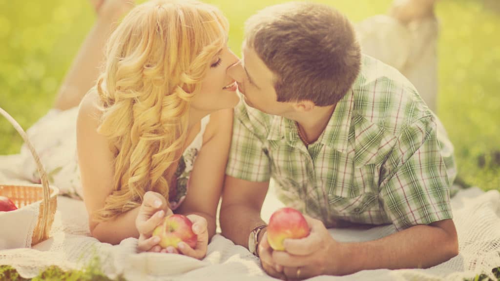 Married couple about to kiss during a picnic